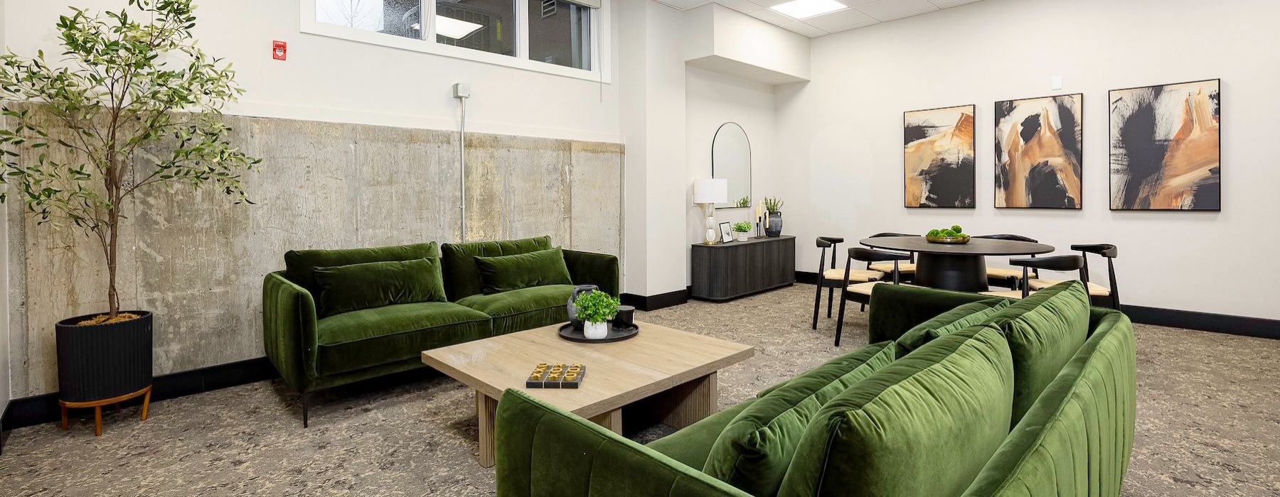 a spacious lounge with green sofas