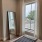 a bedroom with a mirror and a window