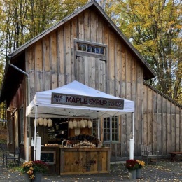 a barn with a tent in front of it