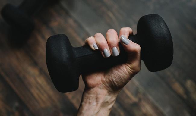 a person's hand holding a dumbbell